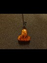 Between amber pendant Thor's Hammer